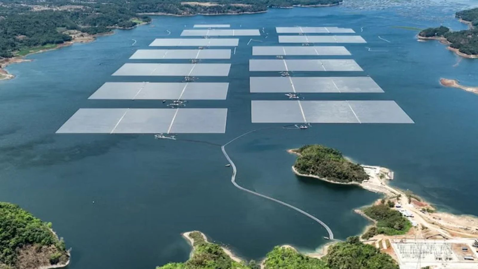 Large floating solar panel arrays installed across a reservoir.